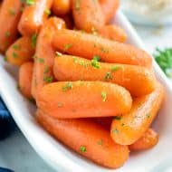 Healthy side dish recipe for honey carrots with a brown sugar glaze that were made in a slow cooker.