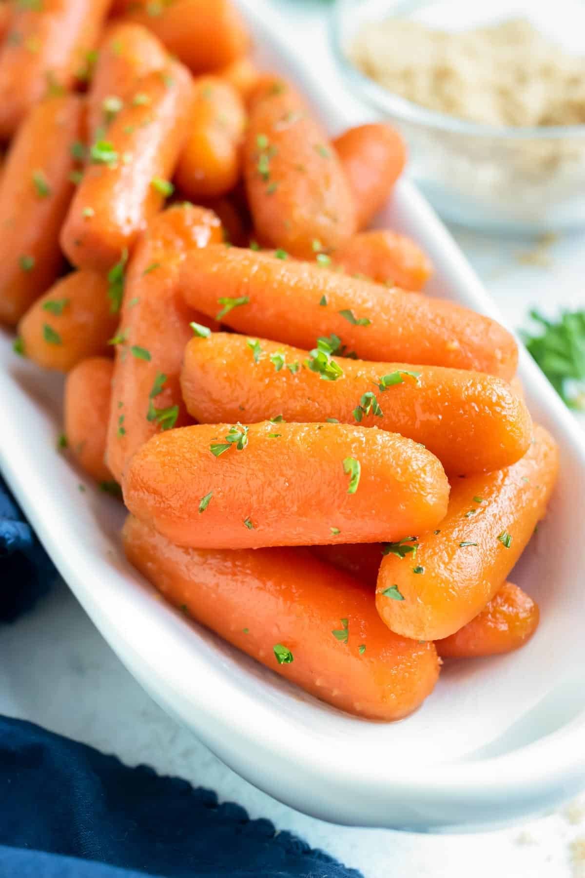 Healthy side dish recipe for honey carrots with a brown sugar glaze that were made in a slow cooker.