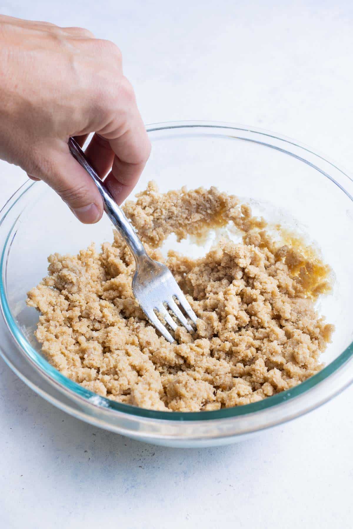Butter, brown sugar, and seasonings are mixed with a fork.