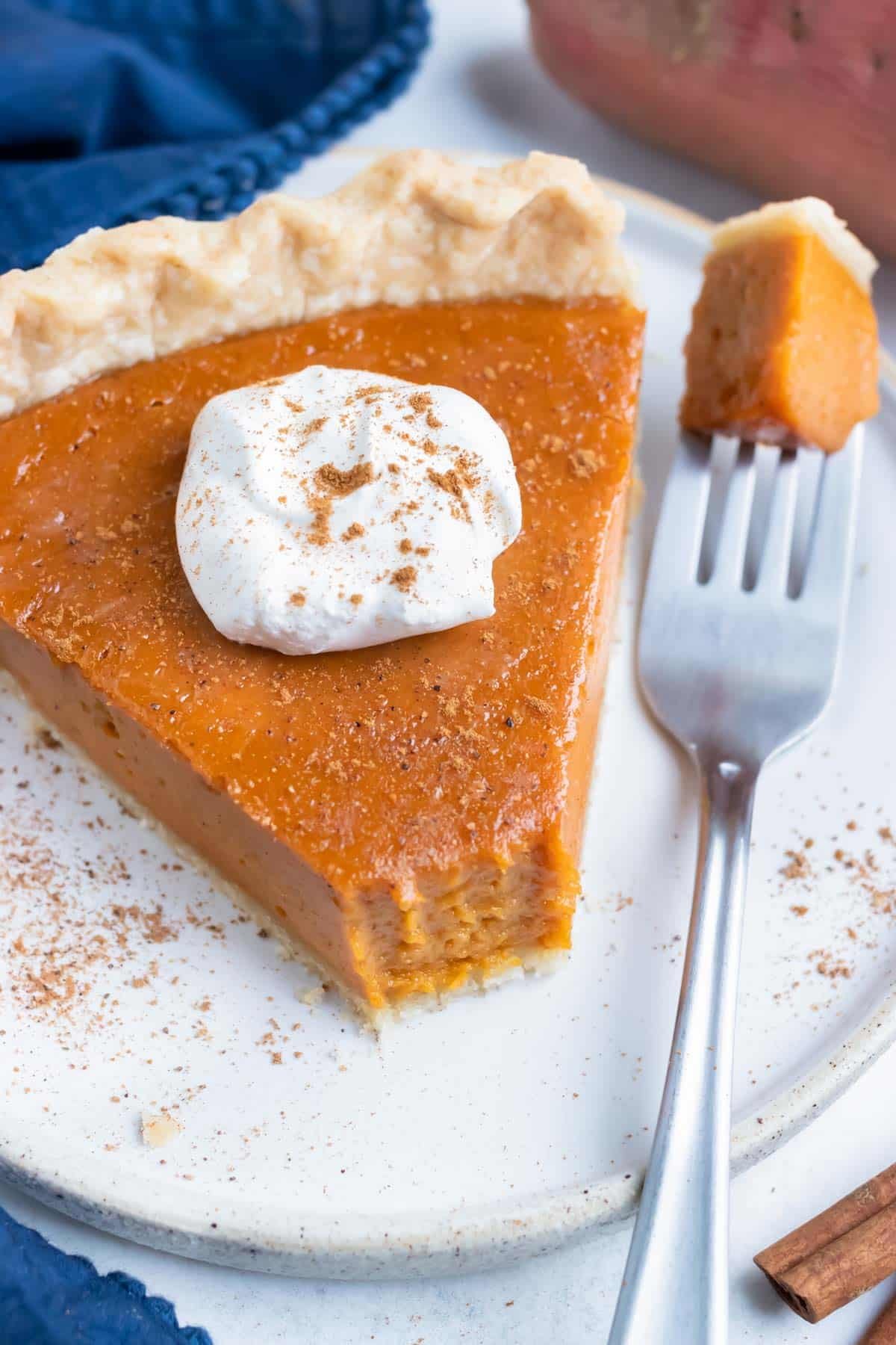 A piece of homemade sweet potato pie is eaten for Thanksgiving.