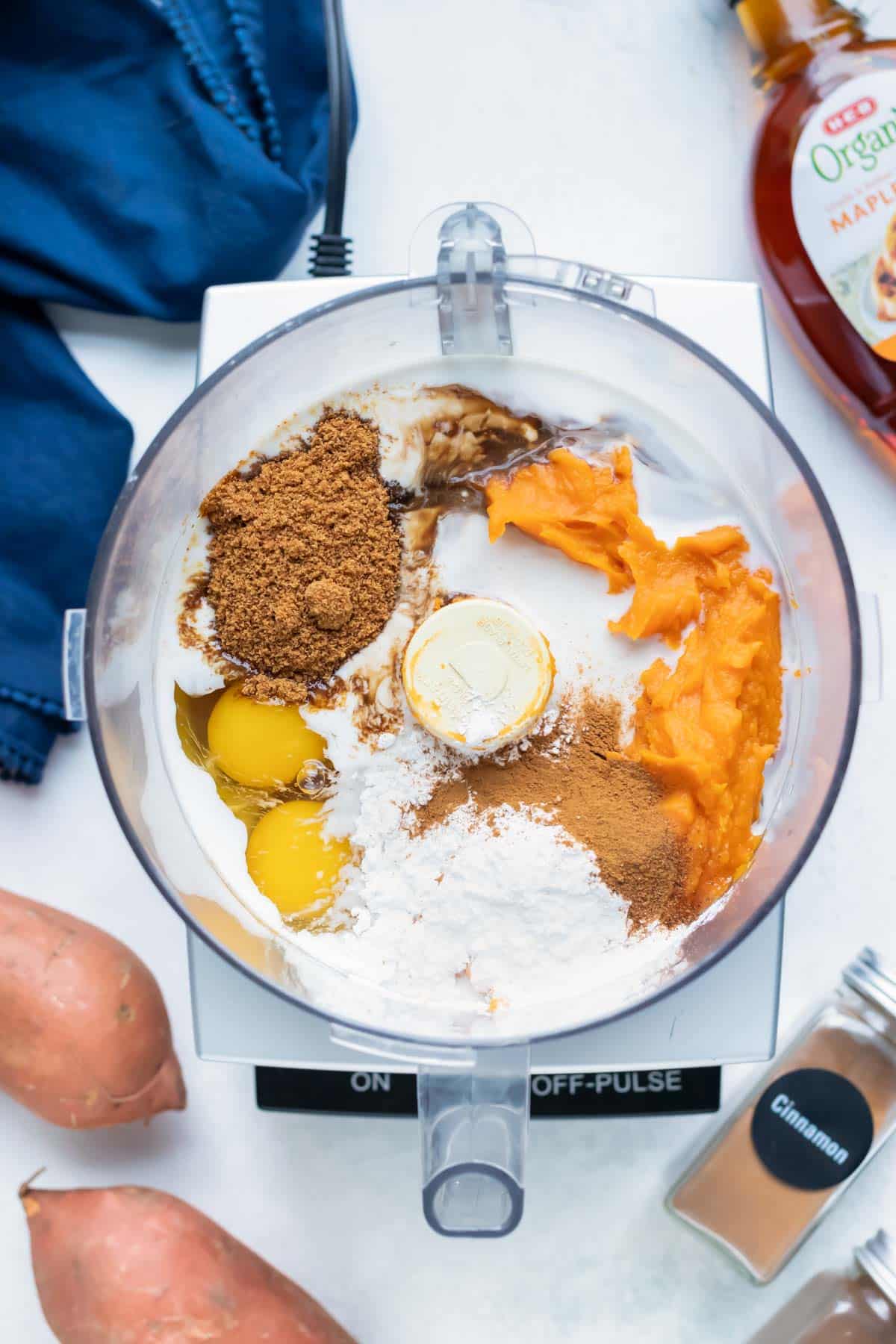 Sweet potato puree, eggs, spices, sweeteners, and other filling ingredients are combined in a food processor.