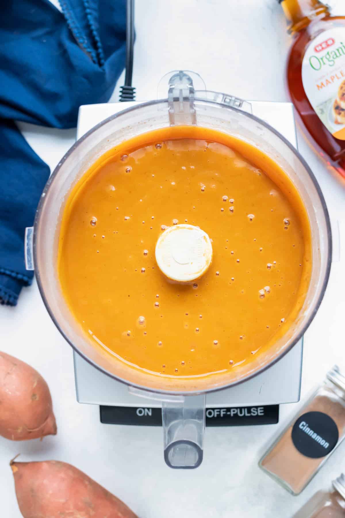 Ingredients are pureed together in a food mixer for a creamy sweet potato pie filling.