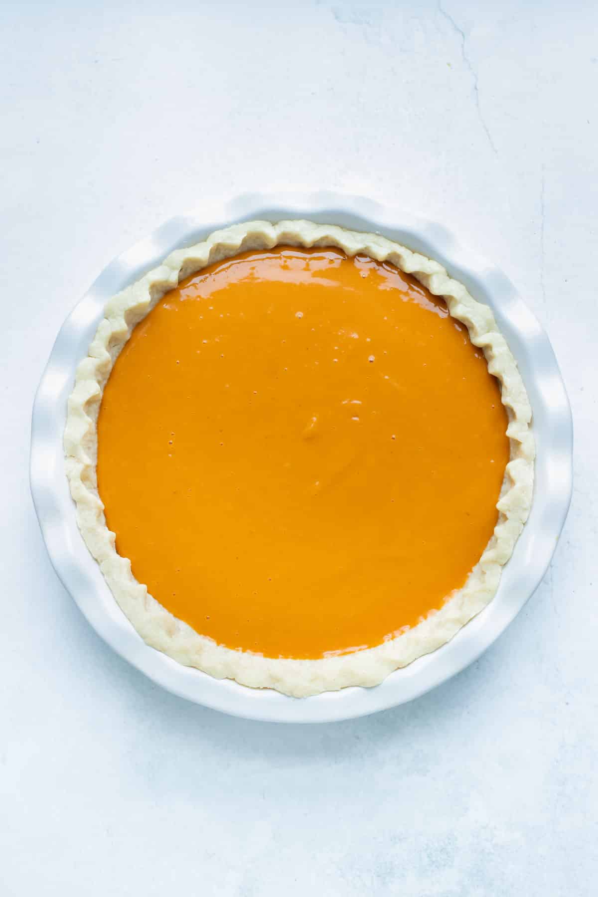 Southern sweet potato pie is filled and put in the oven.
