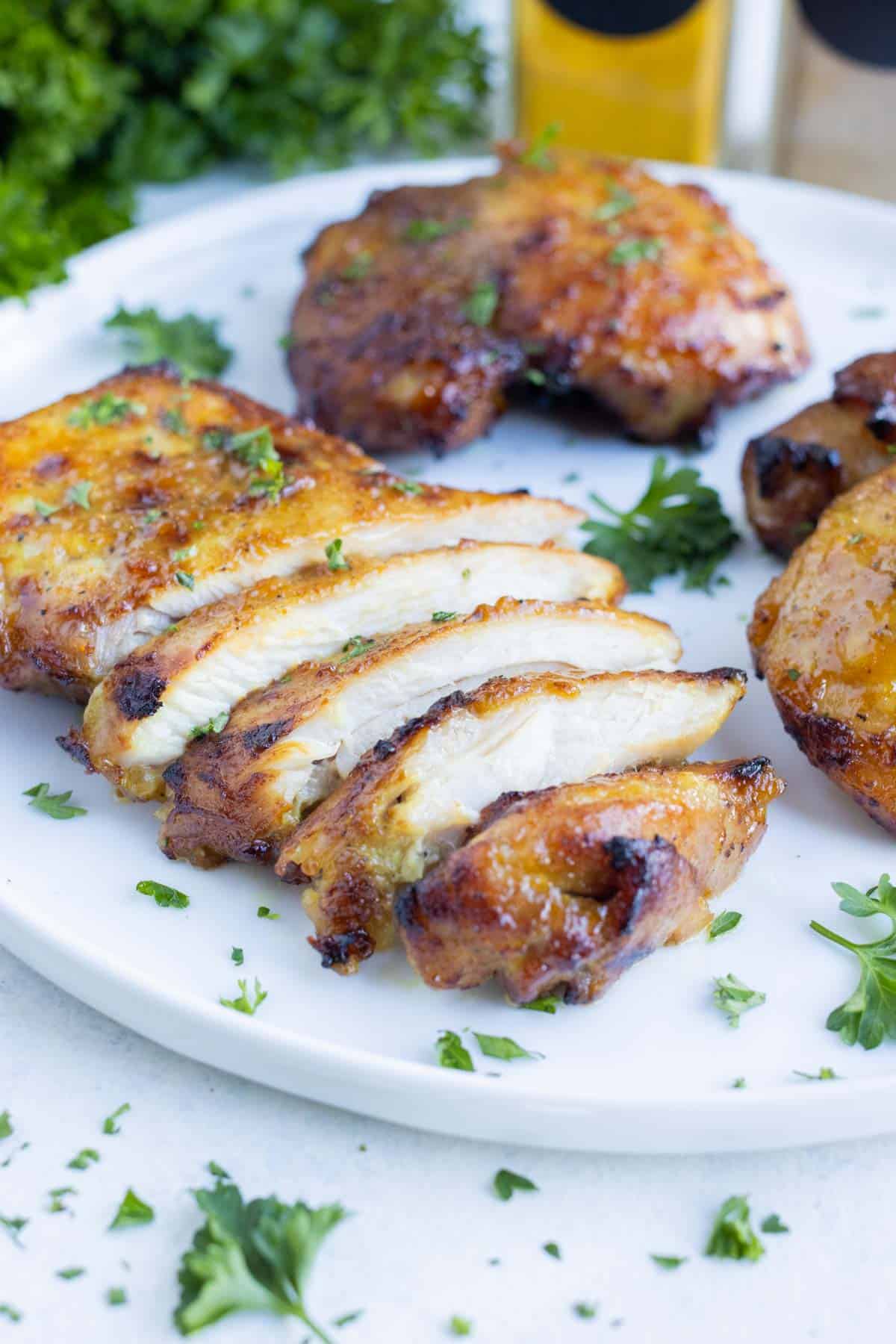 A plate full of chicken thighs cooked in the air fryer.