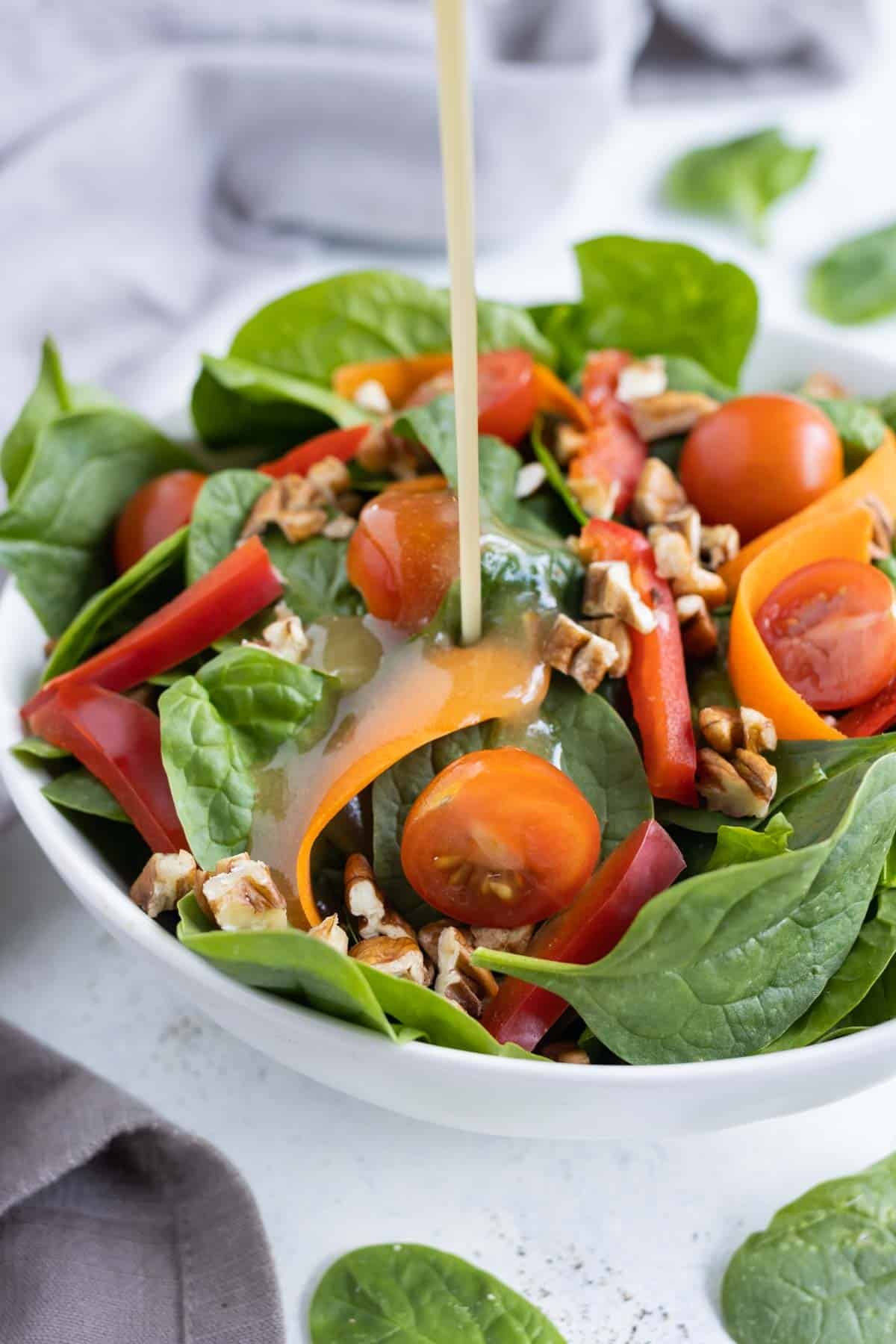 A salad topped with apple cider vinaigrette.