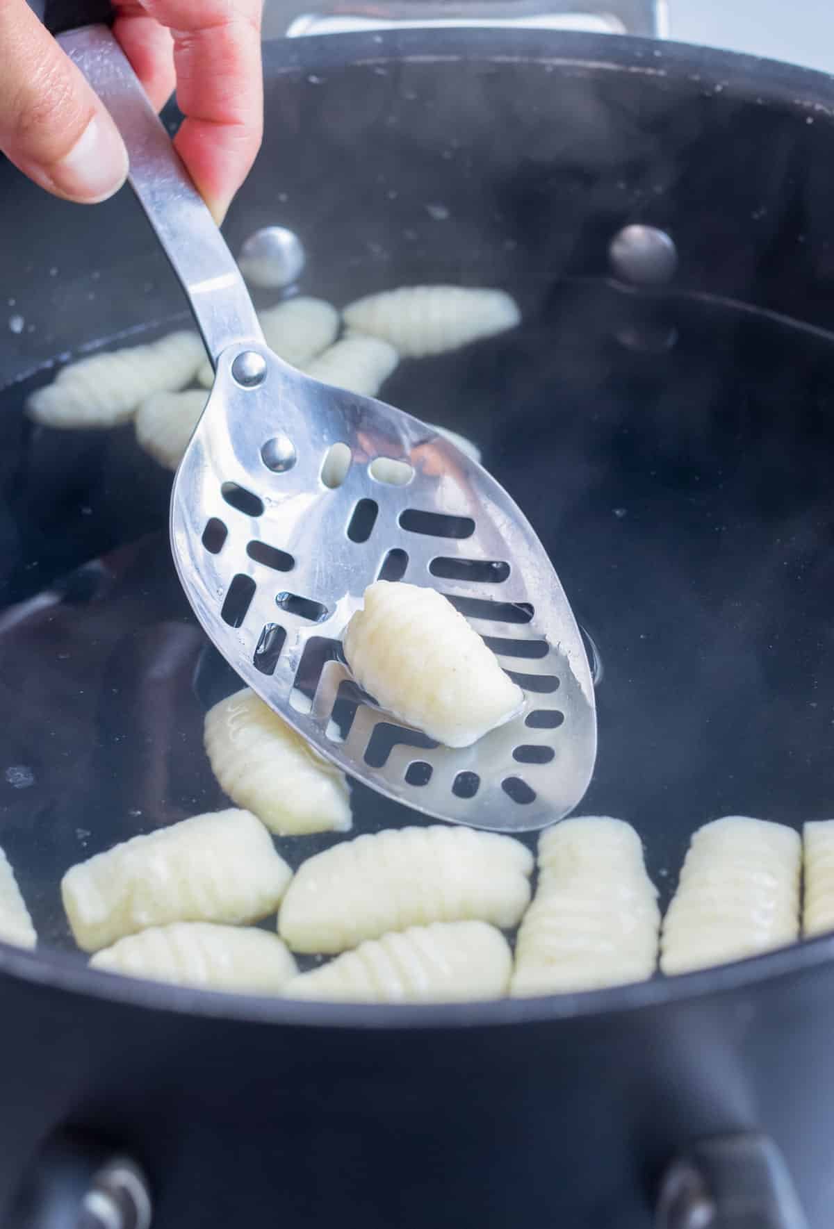 Gnocchi is boiled in a pot before it floats.