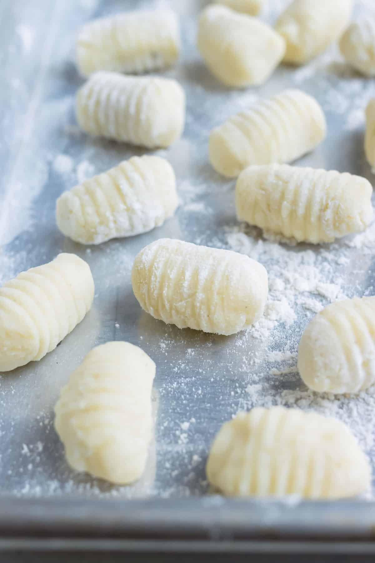 Gluten-free gnocchi is set on a floured surface until cooking.