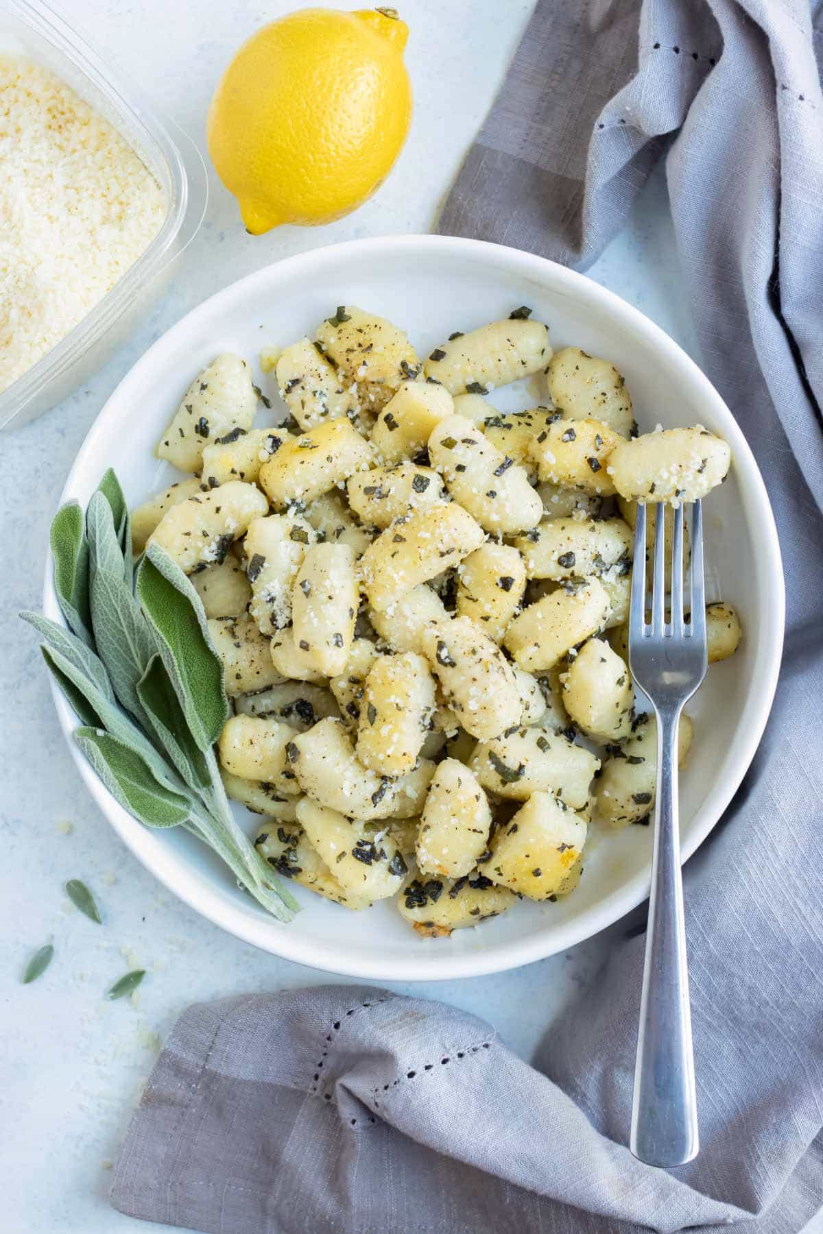 Lemon sage sauce is used to accompany the homemade gnocchi in a bowl.