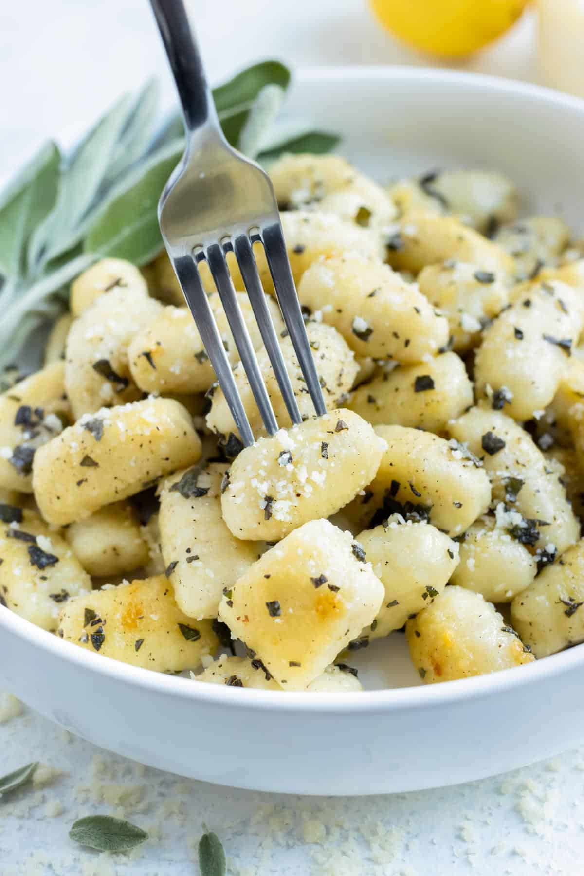 Gluten-free gnocchi is enjoyed with a fork from a bowl.