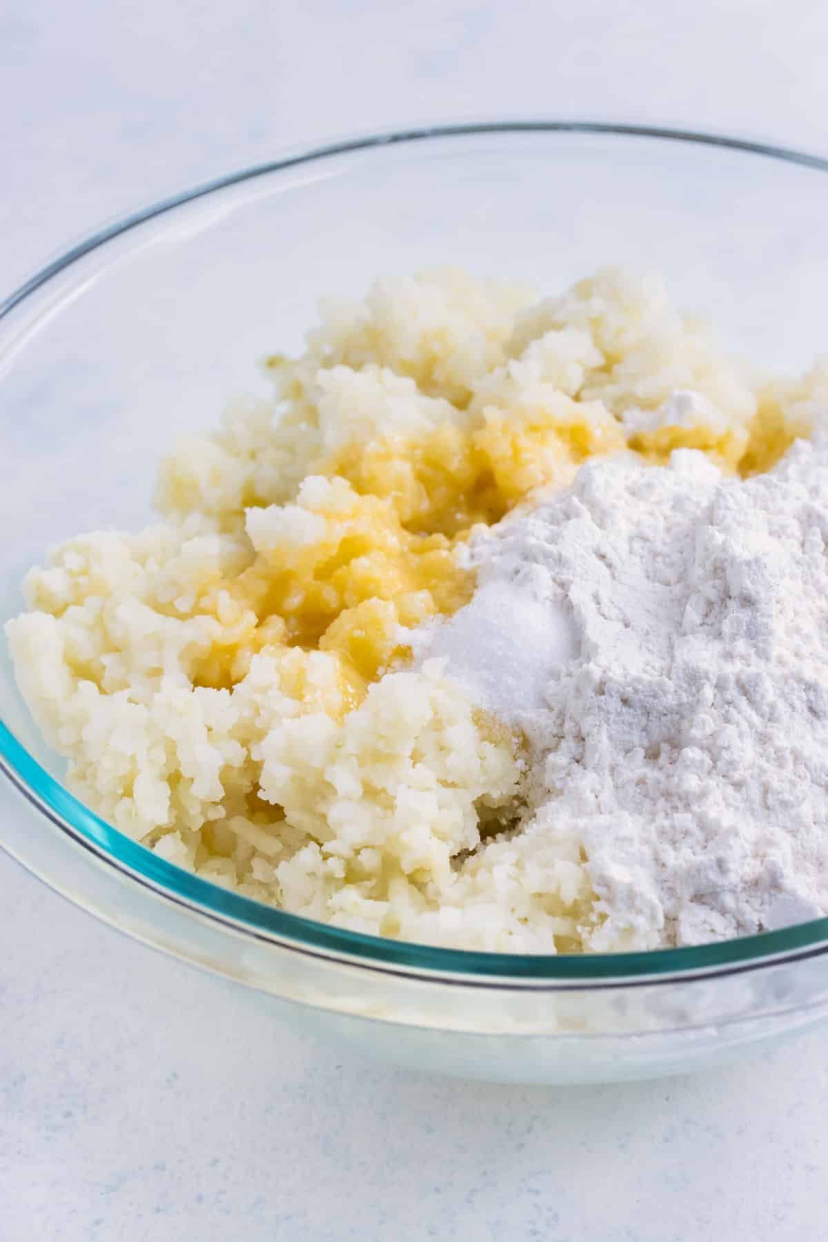 Flour and butter are added to mashed potatoes.