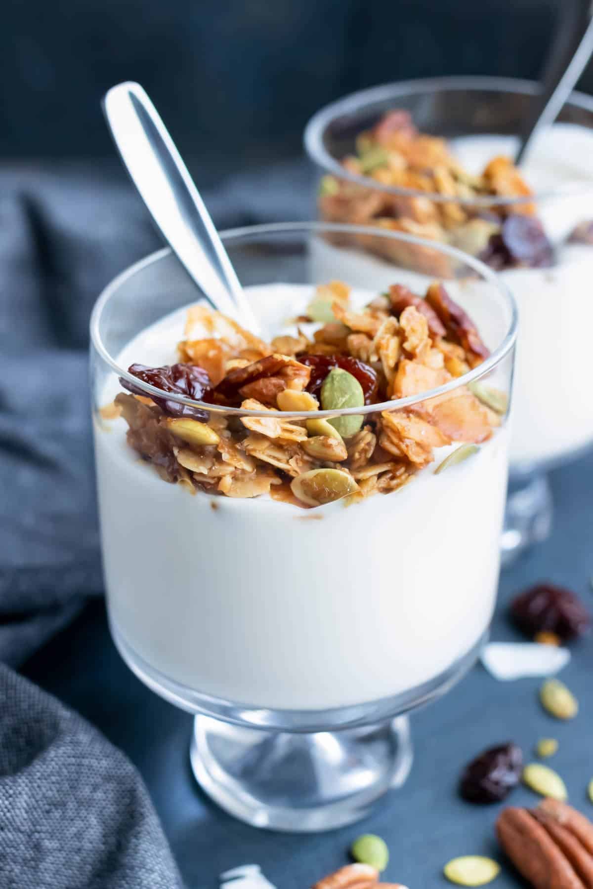Yogurt in a glass with healthy granola on top for an easy breakfast recipe idea.