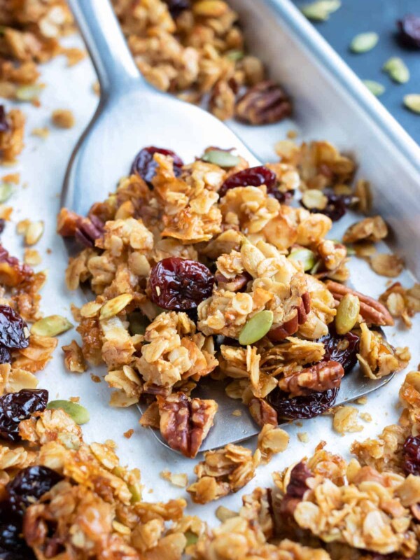 A baking sheet full of an easy and healthy granola recipe with cherries, pecans, and coconut.
