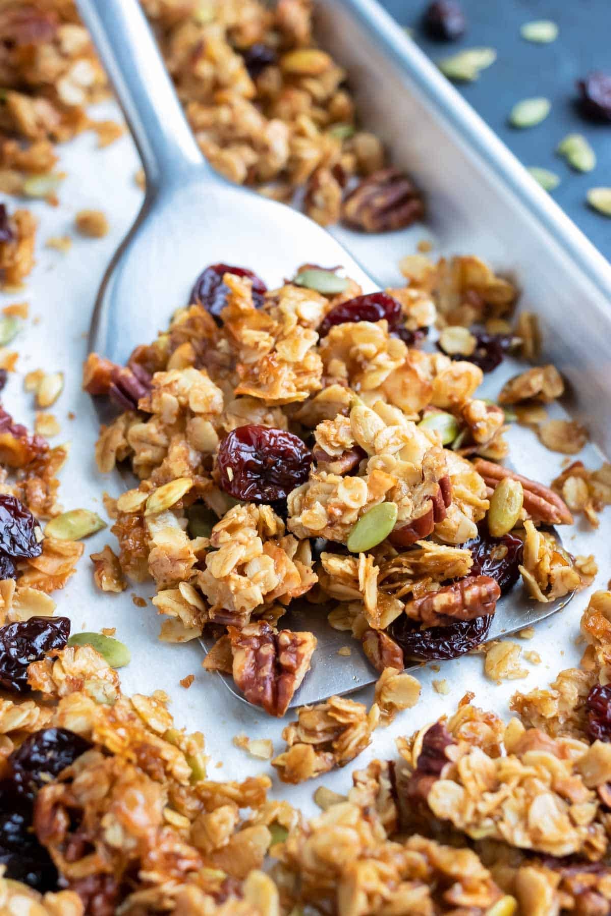 A baking sheet full of an easy and healthy granola recipe with cherries, pecans, and coconut.