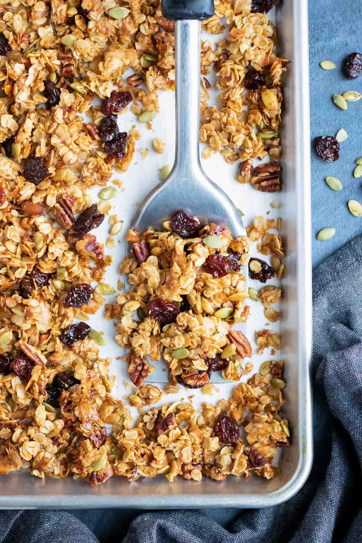 A baking sheet full of an easy and healthy granola recipe with cherries, pecans, and coconut.