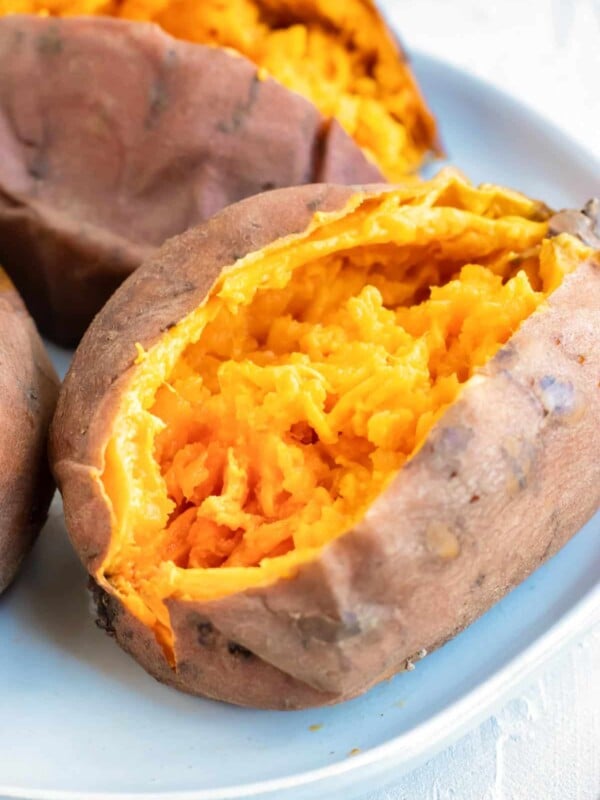 Mashed Instant Pot sweet potato on a white plate.