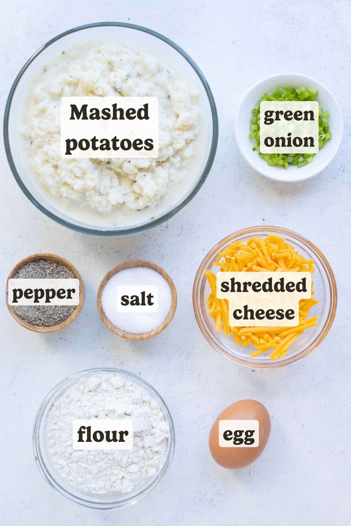 Mashed potatoes, cheese, flour, egg, and seasonings are the ingredients for these potato pancakes.