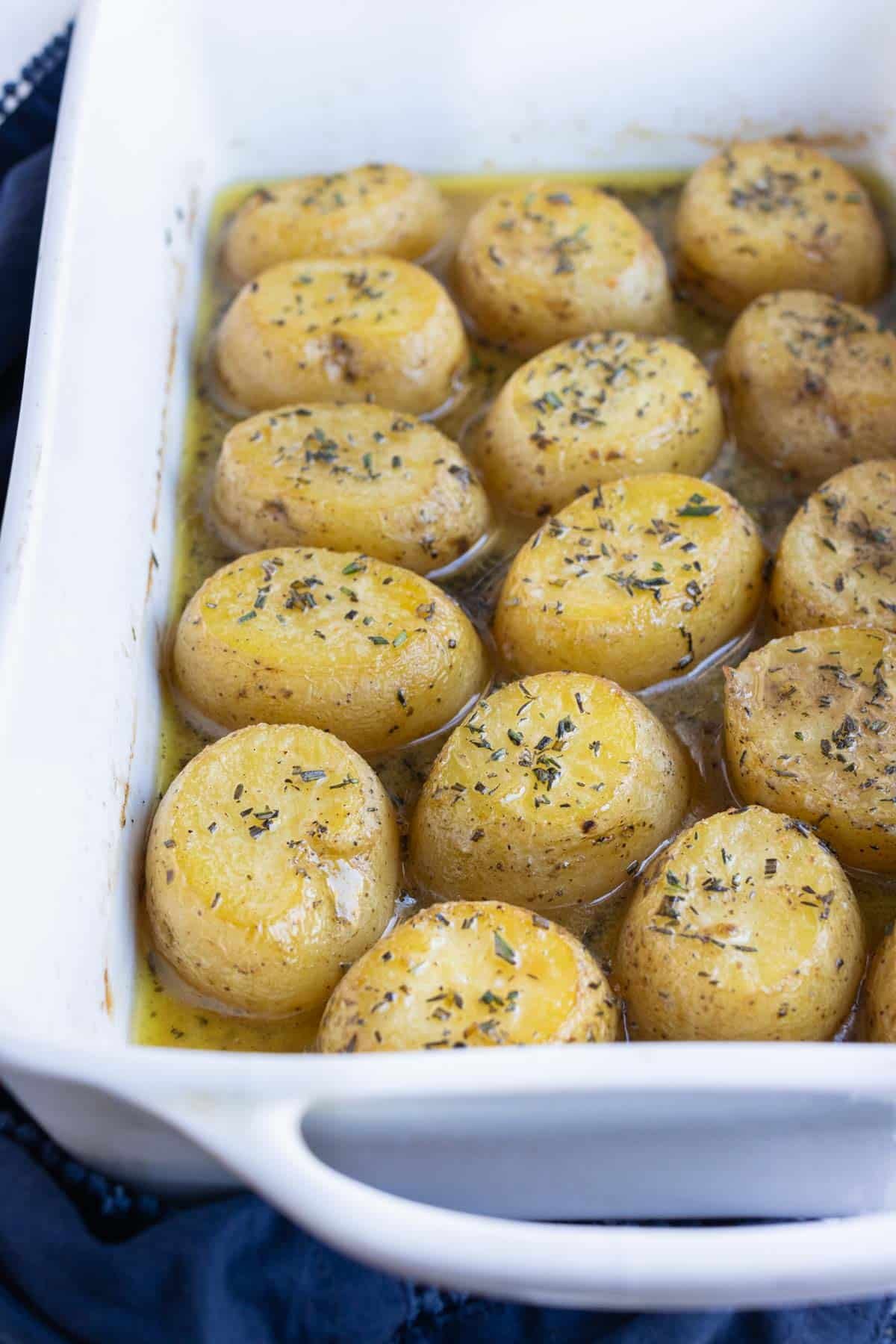 Potatoes are cooked in herb butter and then broth.