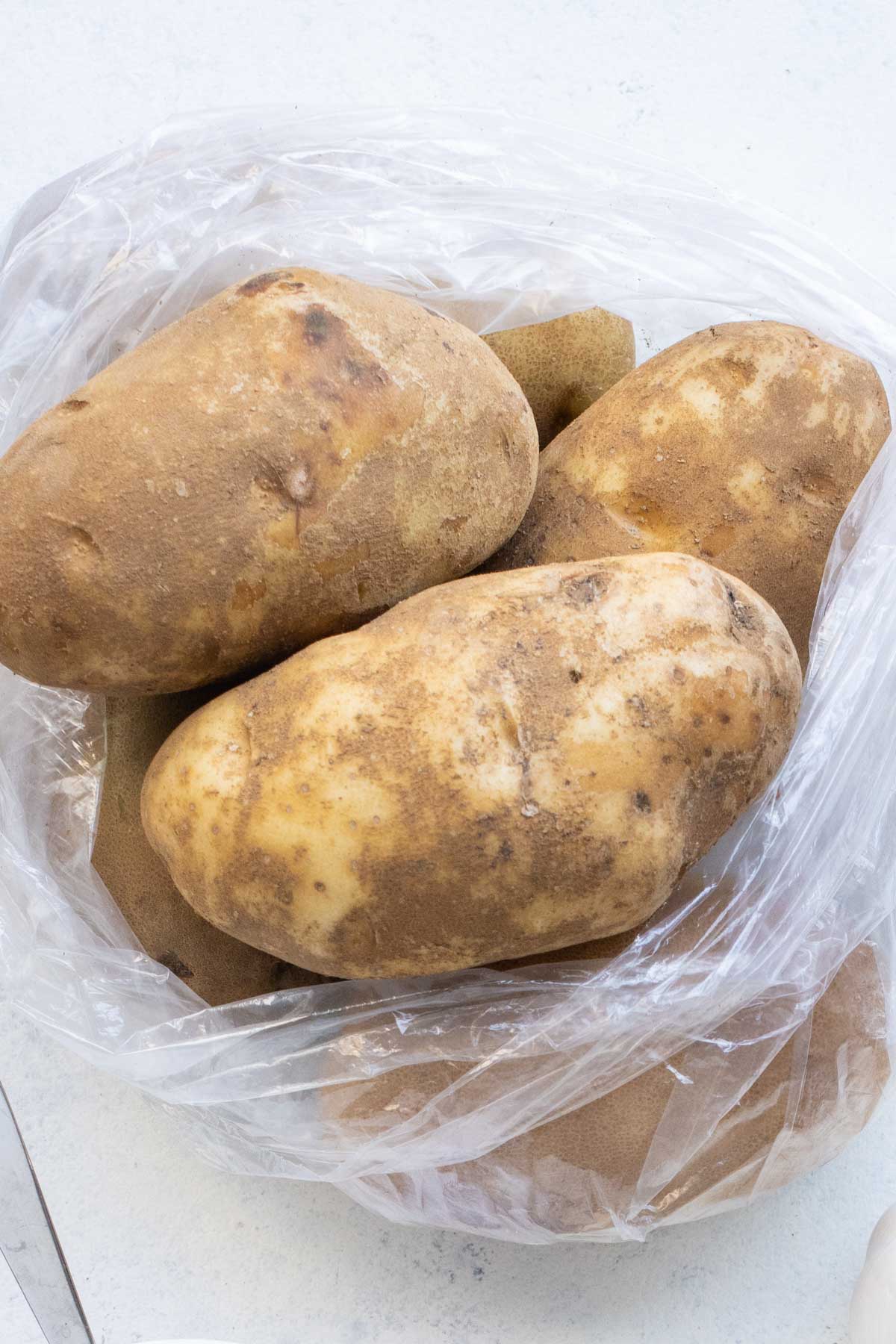 A bag full of russet potatoes.
