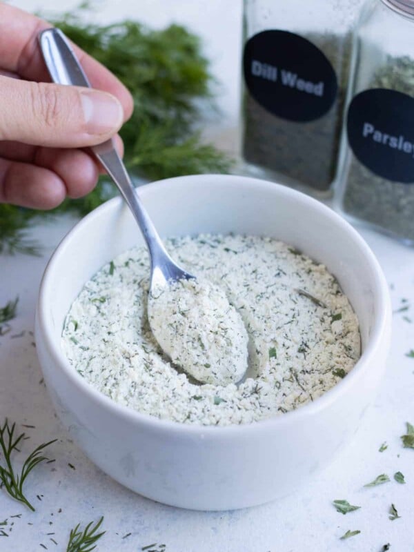 A spoonful of homemade ranch seasoning in a white ramekin.