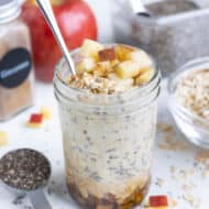 A glass filled with gluten-free apple cinnamon overnight oats for a healthy breakfast.