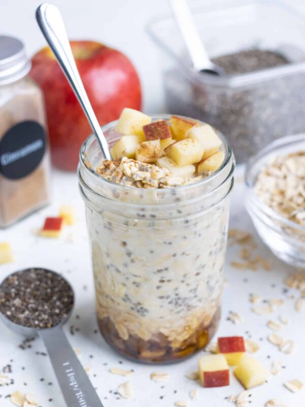 A glass filled with gluten-free apple cinnamon overnight oats for a healthy breakfast.