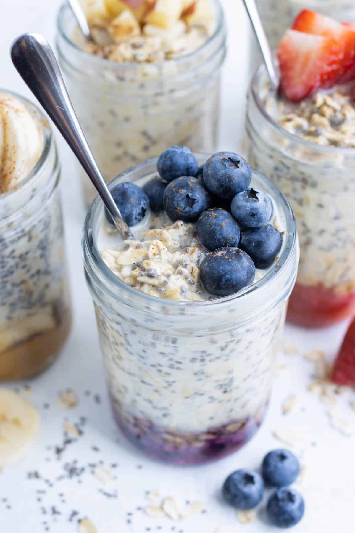 An overhead shot of blueberry overnight oatmeal in a mason jar.