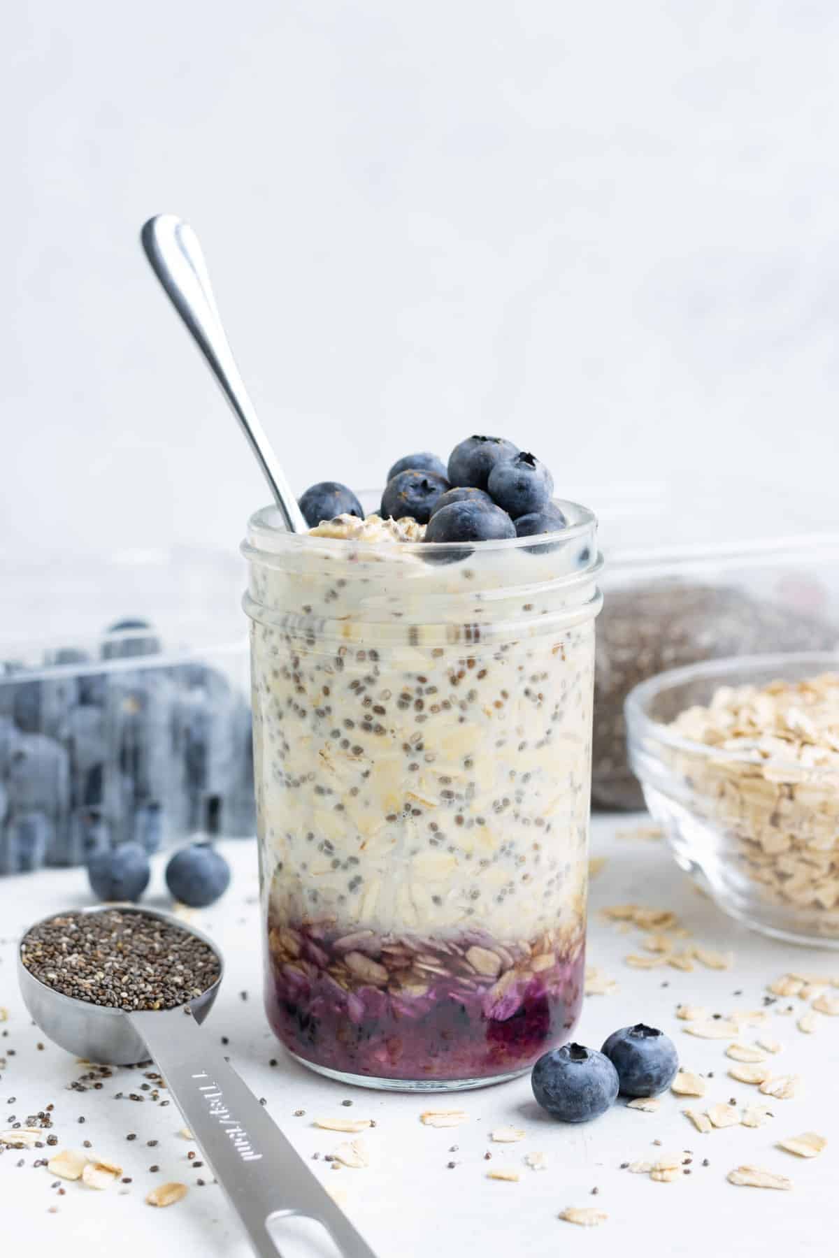 Healthy overnight oats with blueberries in a mason jar.