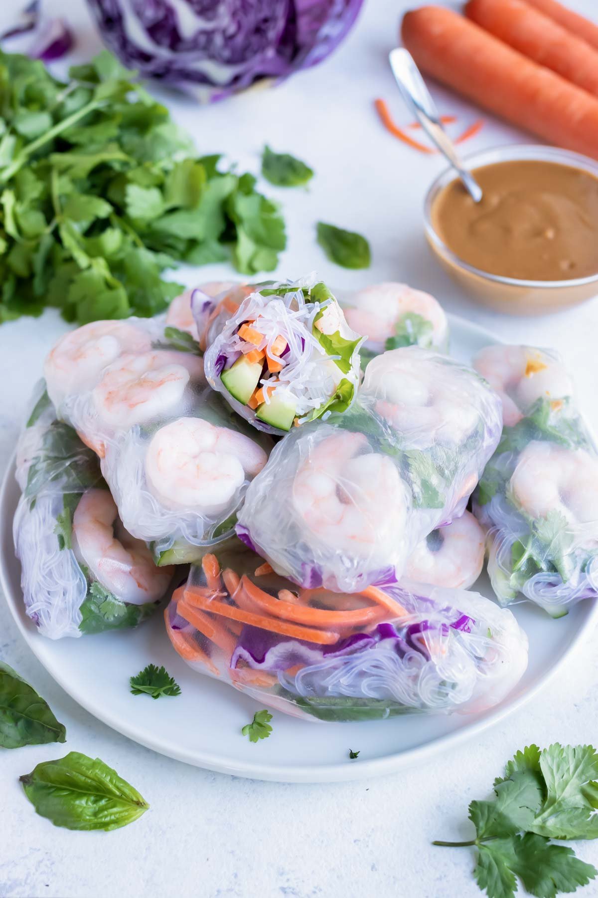 Authentic spring rolls are served on a white plate.