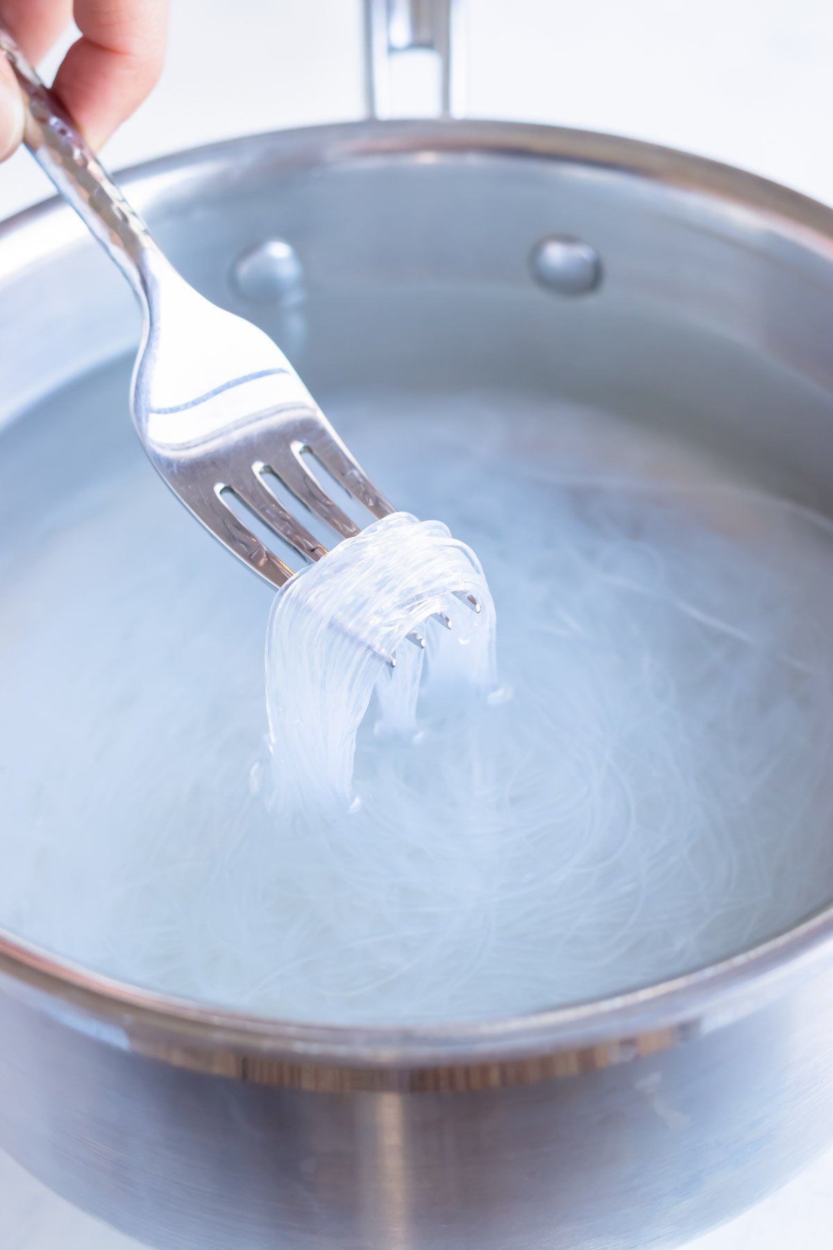 Noodles are pulled out of hot water.