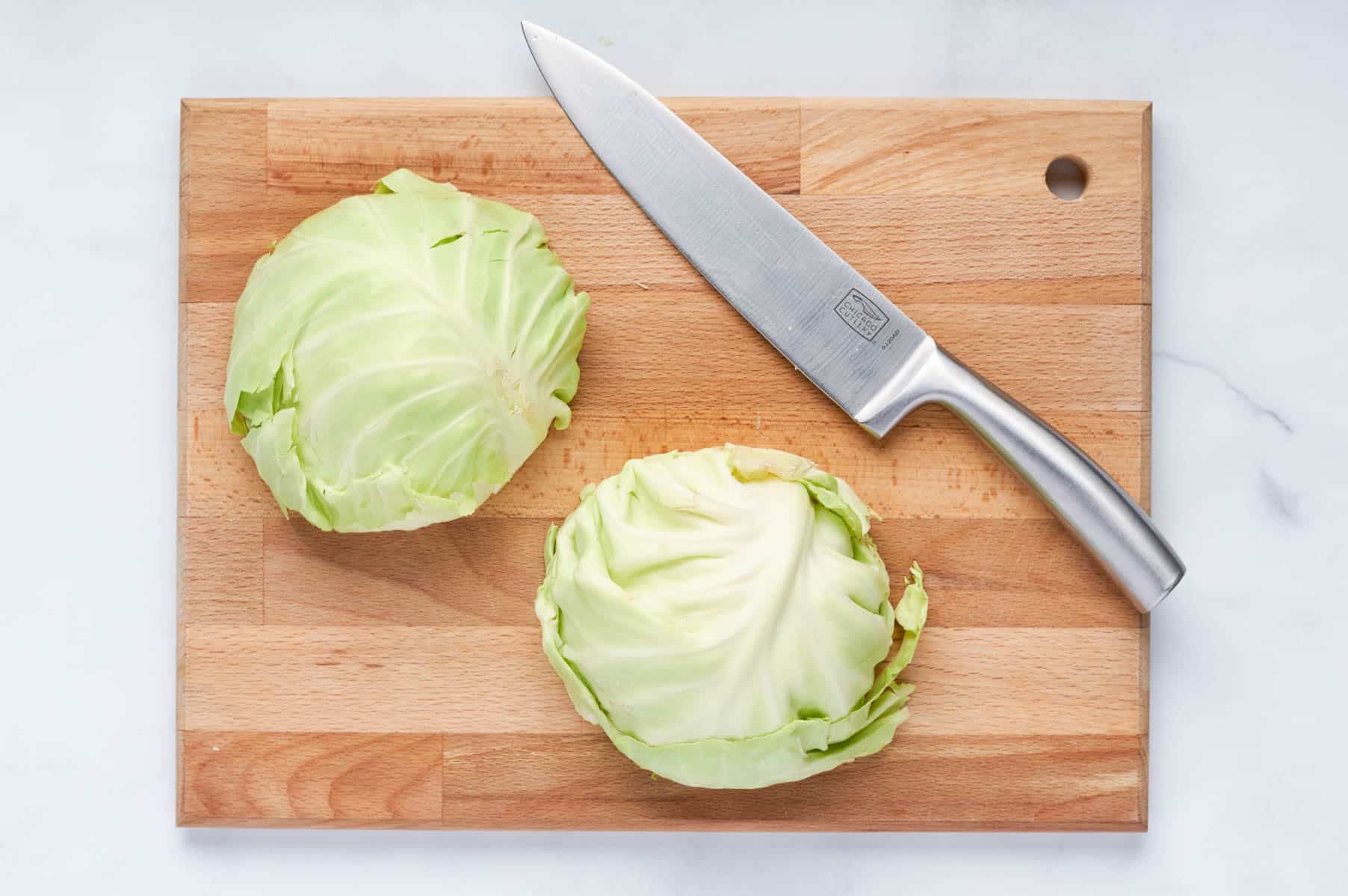 A head of cabbage is sliced in half.