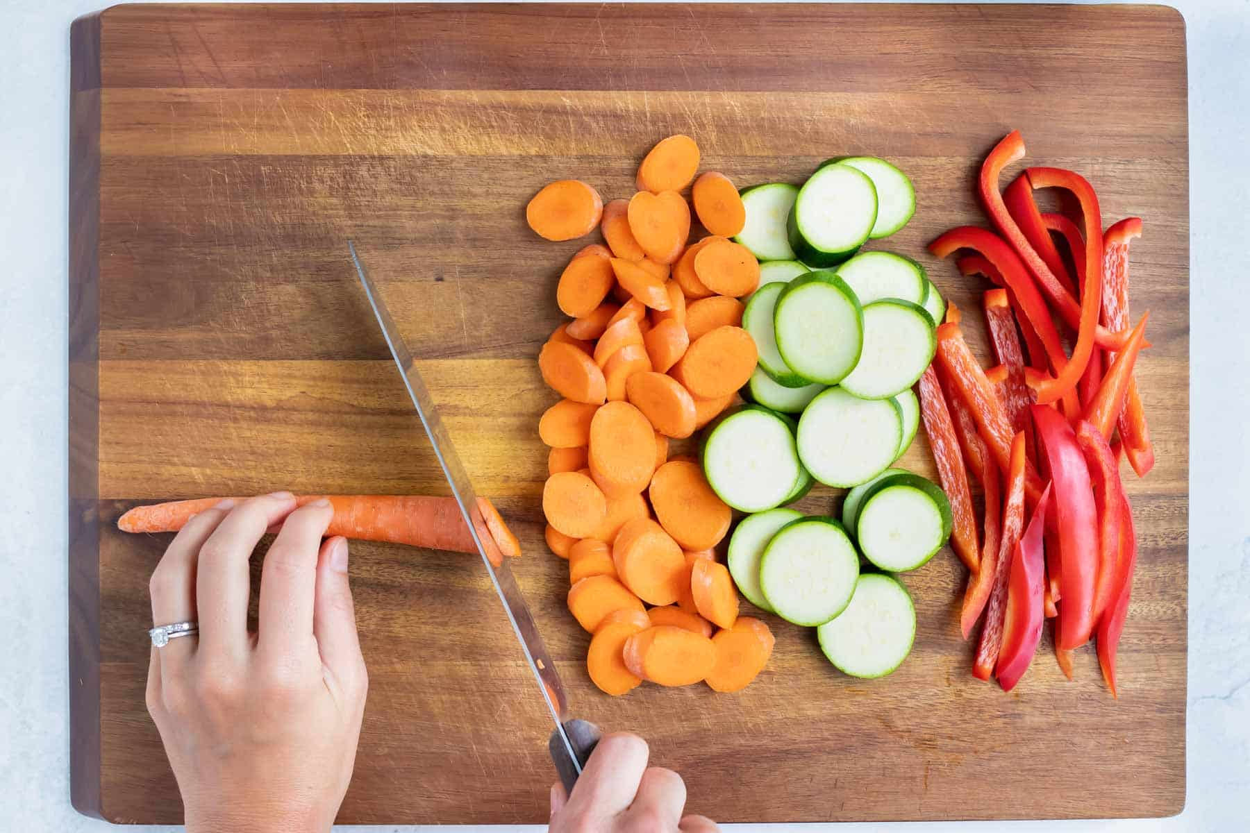 Vegetables are sliced on a cutting board.