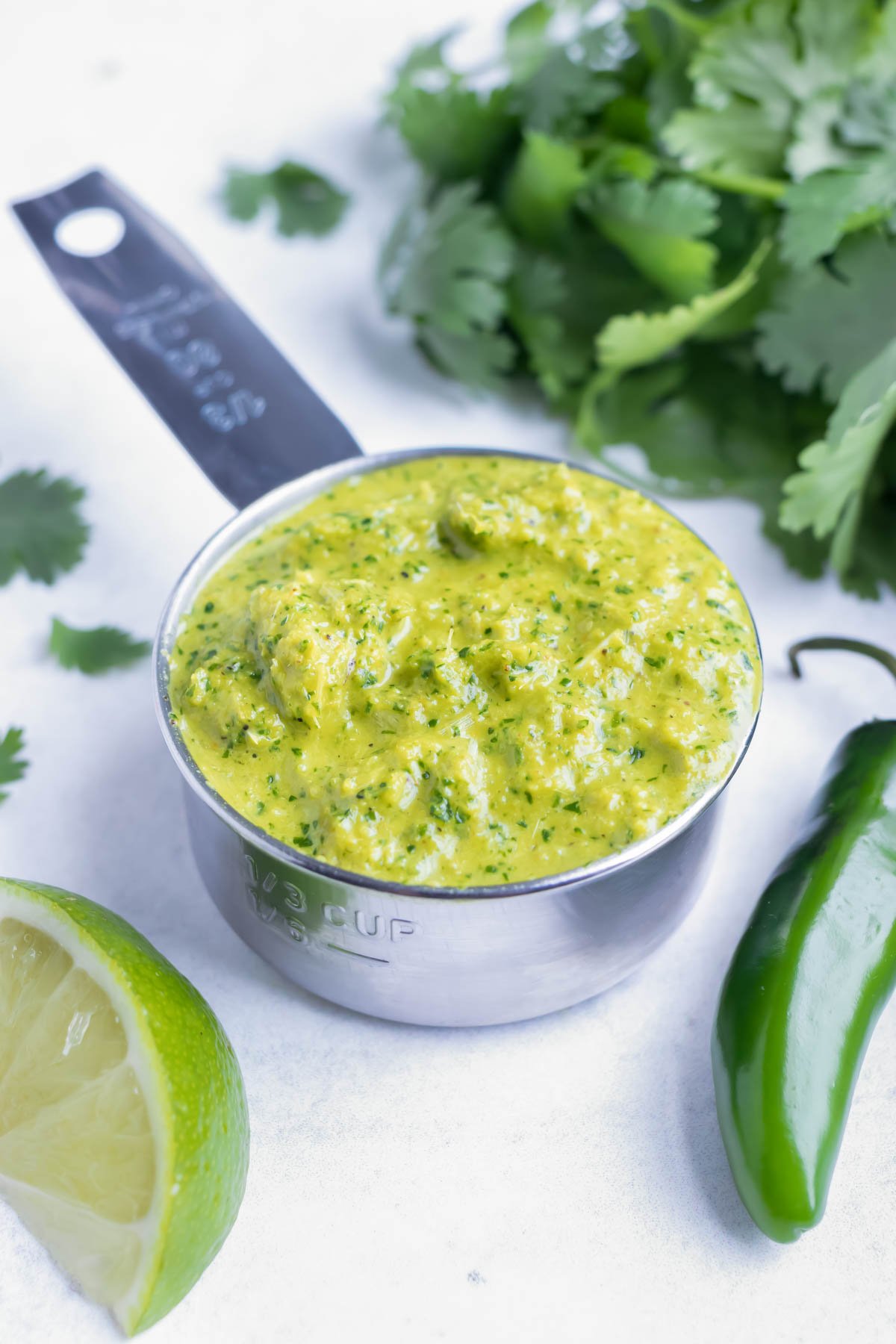 Homemade, gluten-free Thai green curry paste is measured to be used in Green curry chicken.
