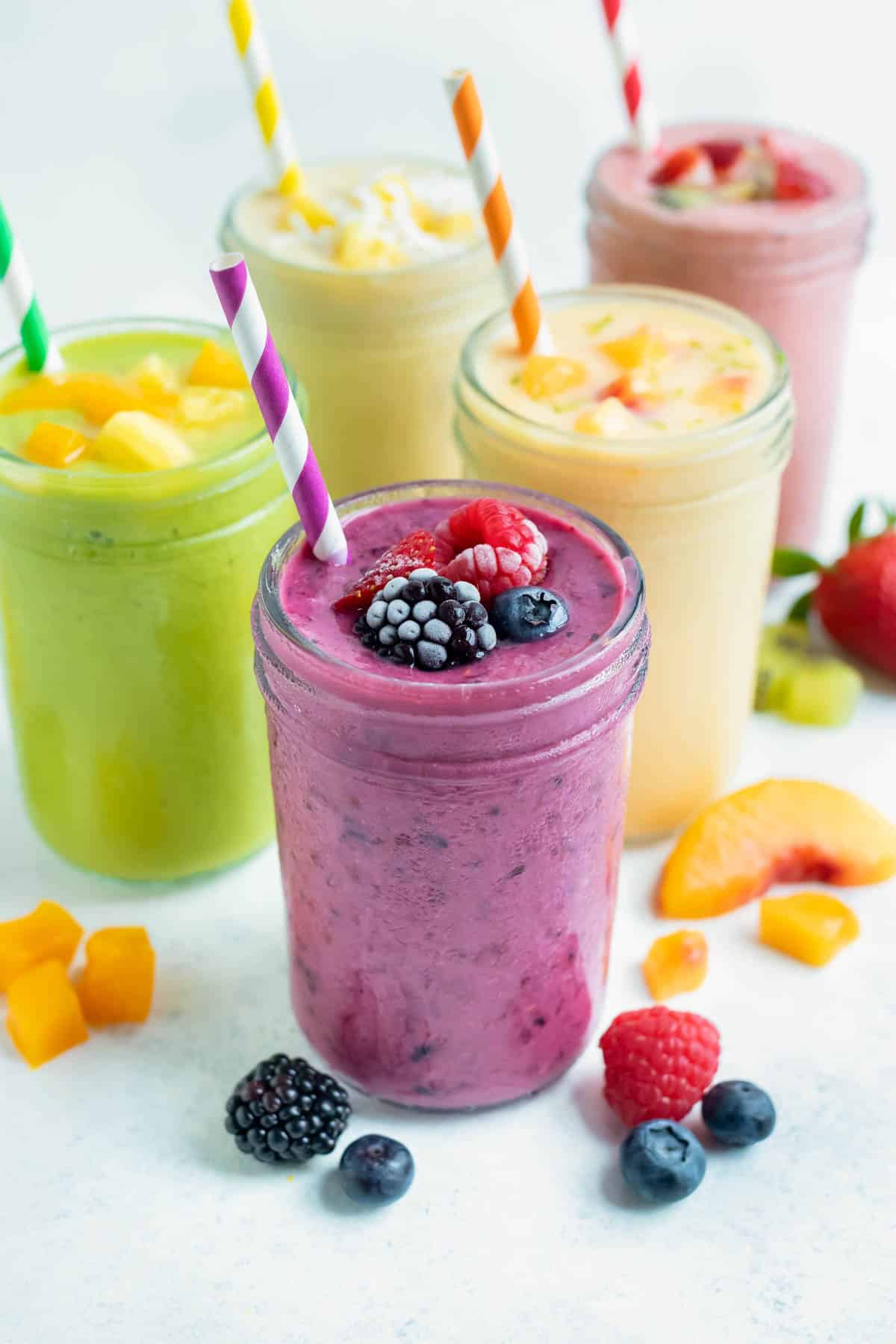 Fruit smoothies are set on the counter and enjoyed for a delicious breakfast drink.