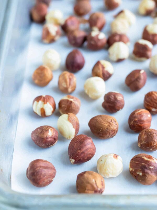 Roasted hazelnuts are made in the oven on a lined baking sheet.