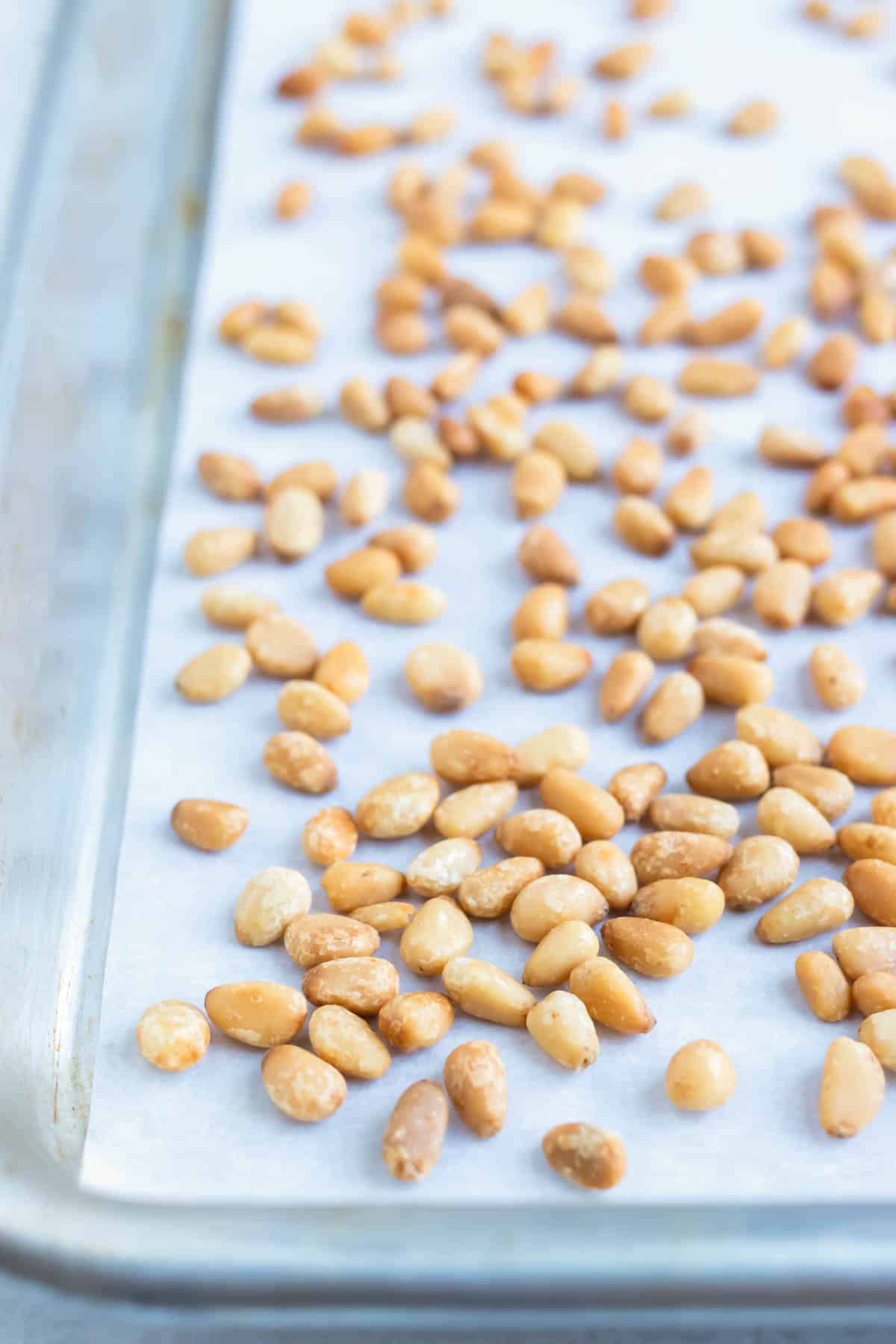 Pine nuts are roasted in the oven for a buttery, crunchy addition to your salad.