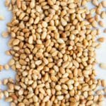 Learn how to quickly and easily toast pine nuts in the oven on a baking sheet.