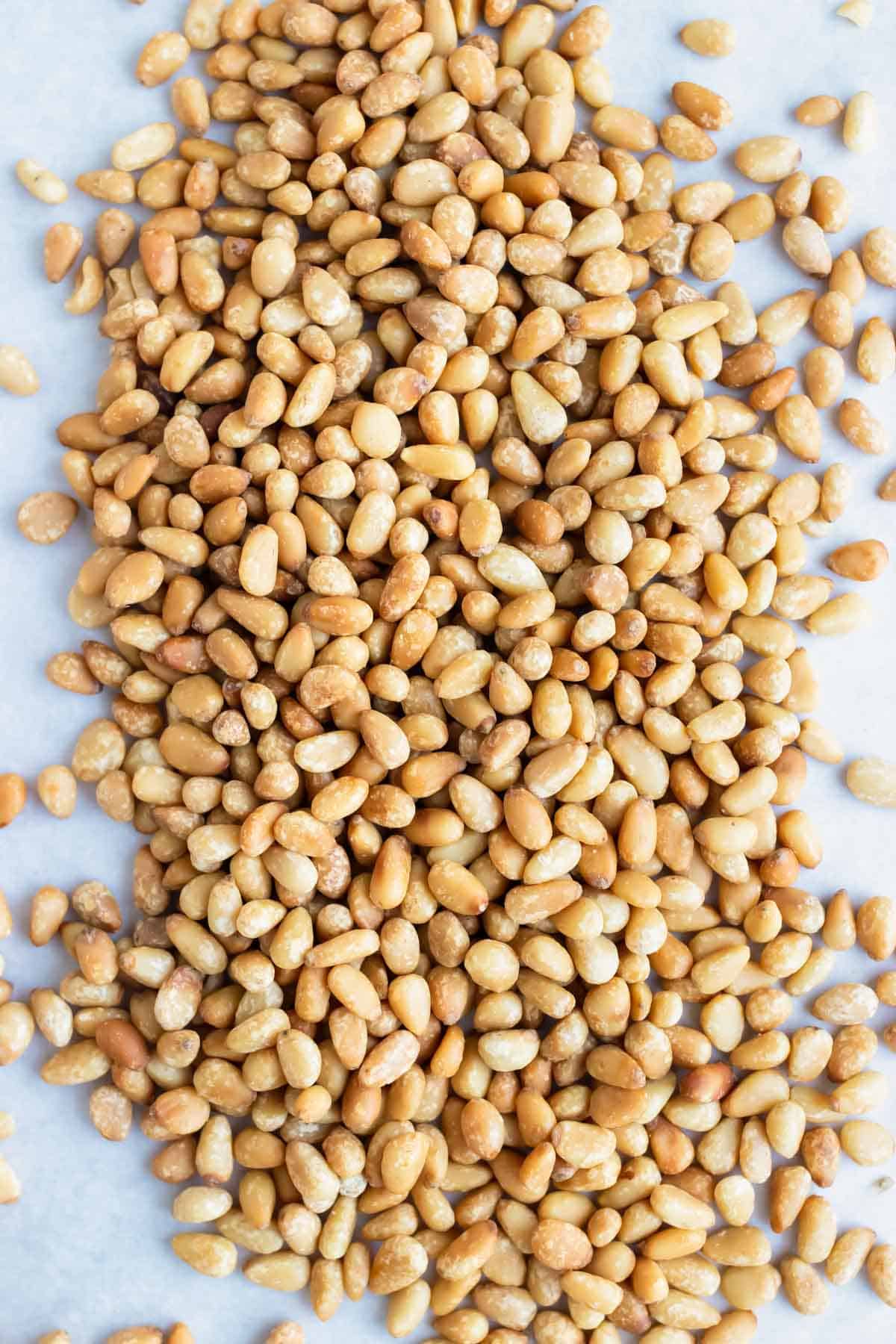 Learn how to quickly and easily toast pine nuts in the oven on a baking sheet.