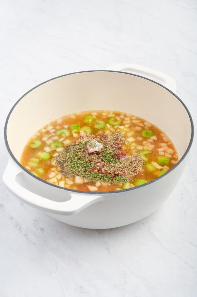 Herbs and spices are added to the soup.