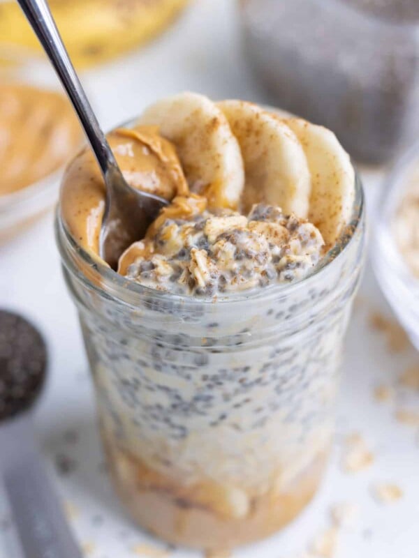 Mason jars are filled with healthy oatmeal ingredients for a quick breakfast.