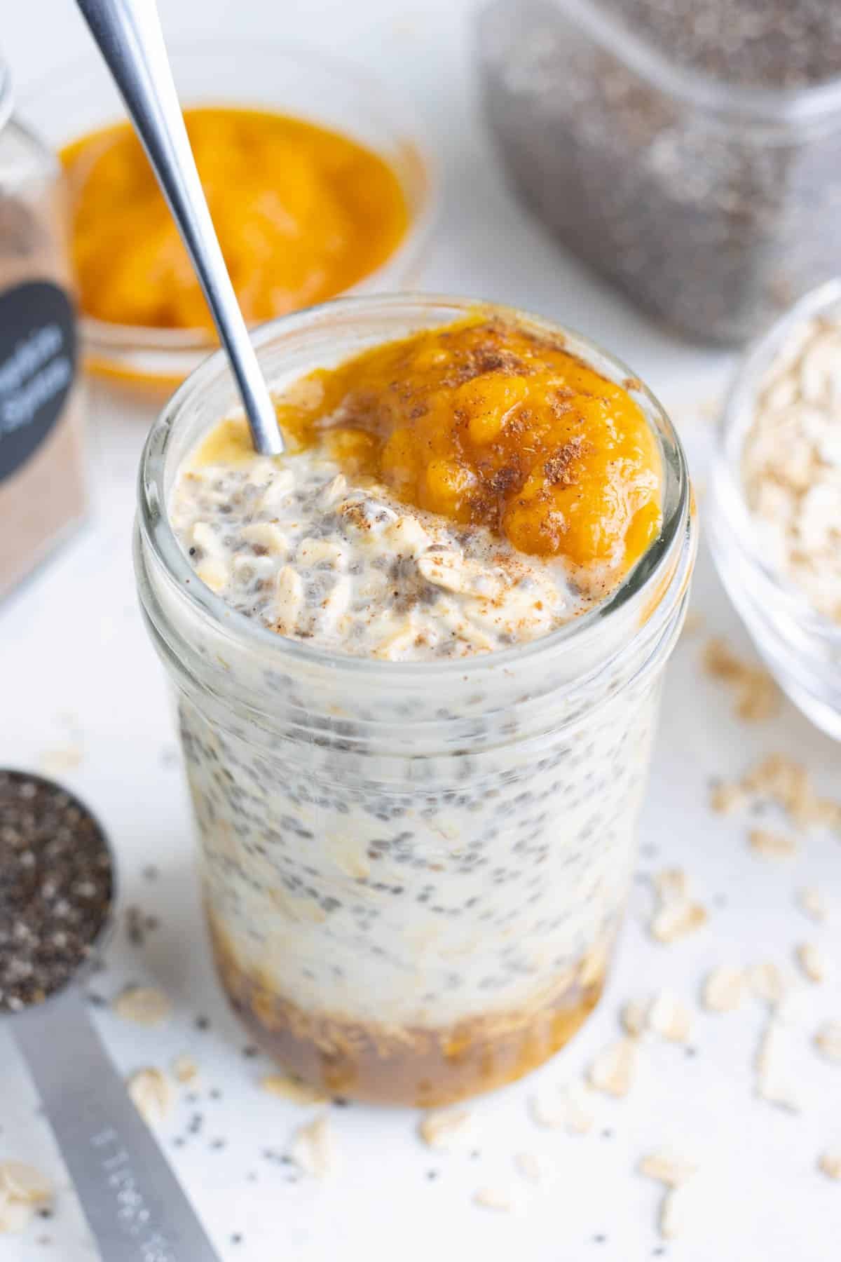 Cold overnight oats served with pumpkin puree and whipped cream.