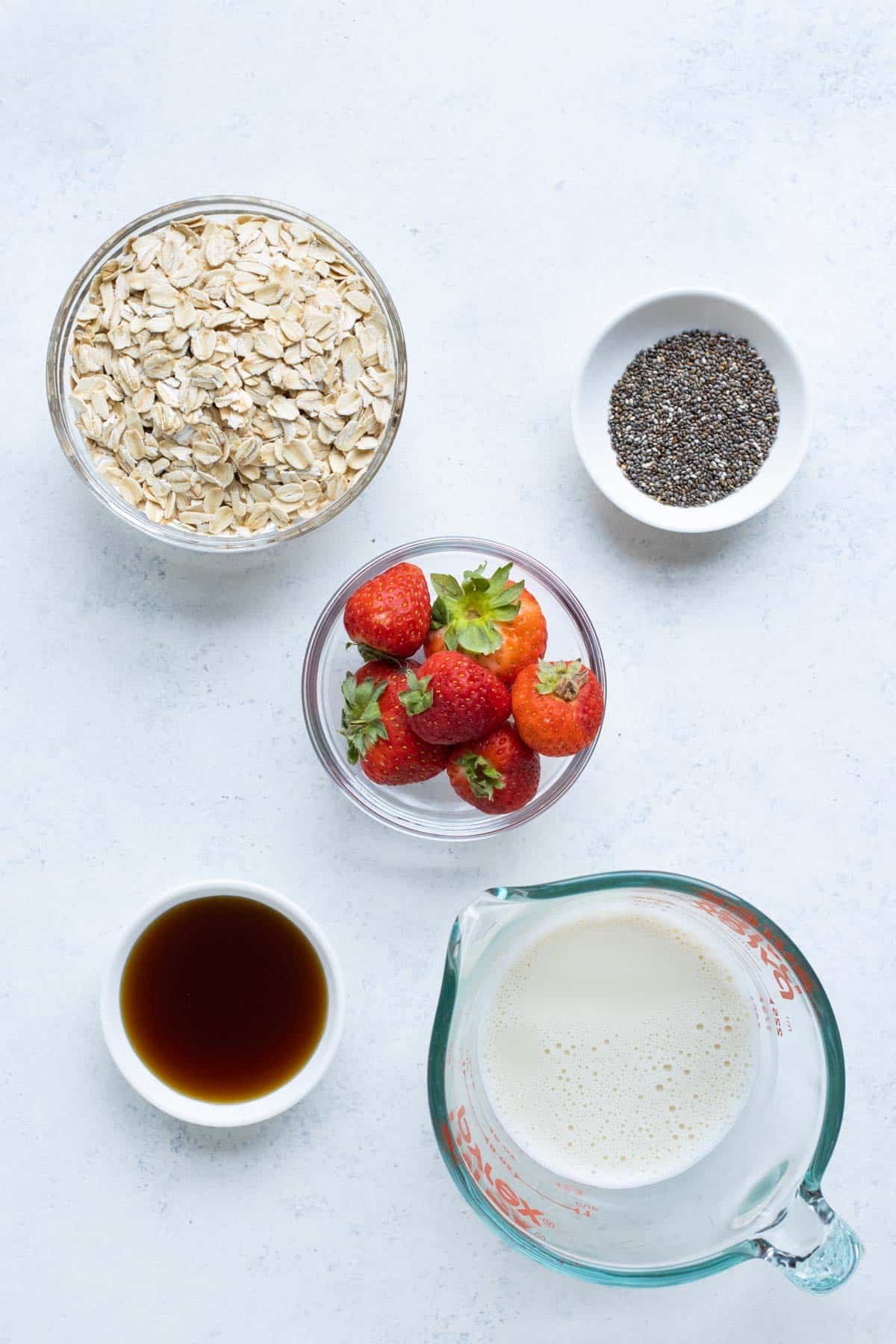 Rolled oats, strawberries, sweetener, milk, and chia seeds are the basic ingredients.