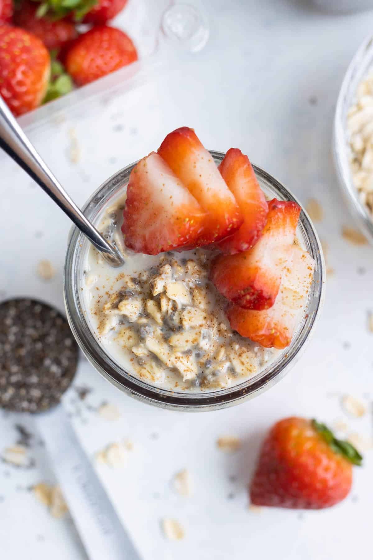 An overhead shot of overnight oats with strawberries.