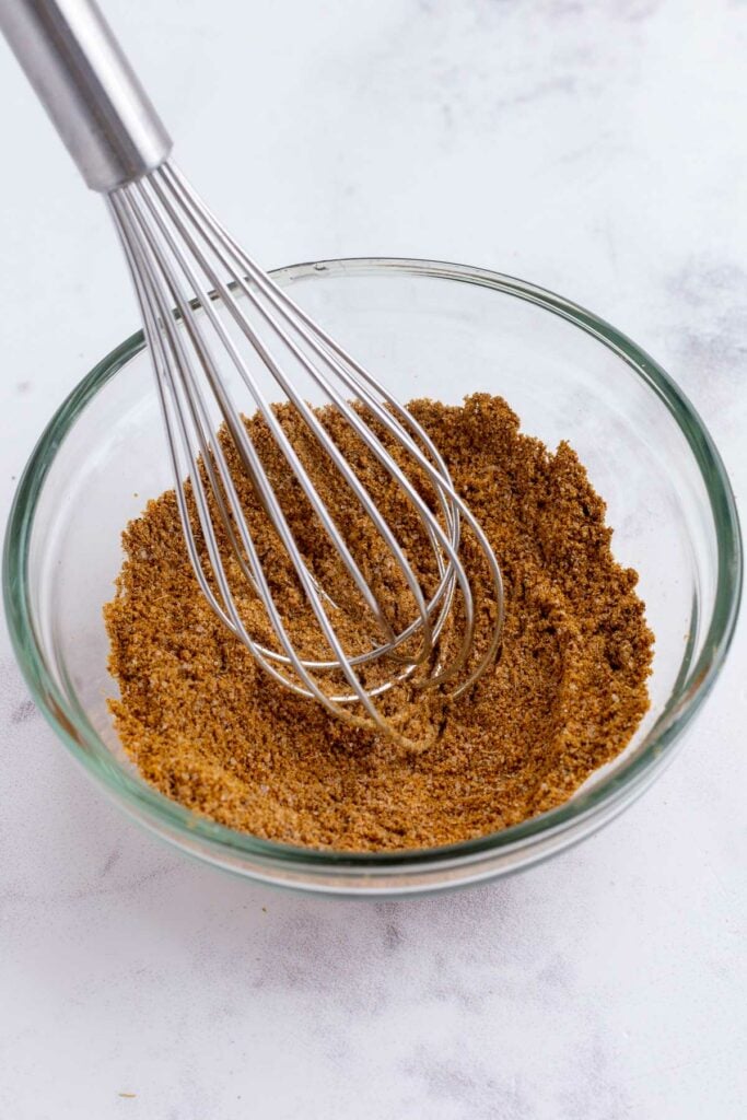 Garam masala spice blend whisked together in a glass bowl for Indian chicken korma