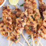 Chicken is skewered on wooden sticks and grilled.