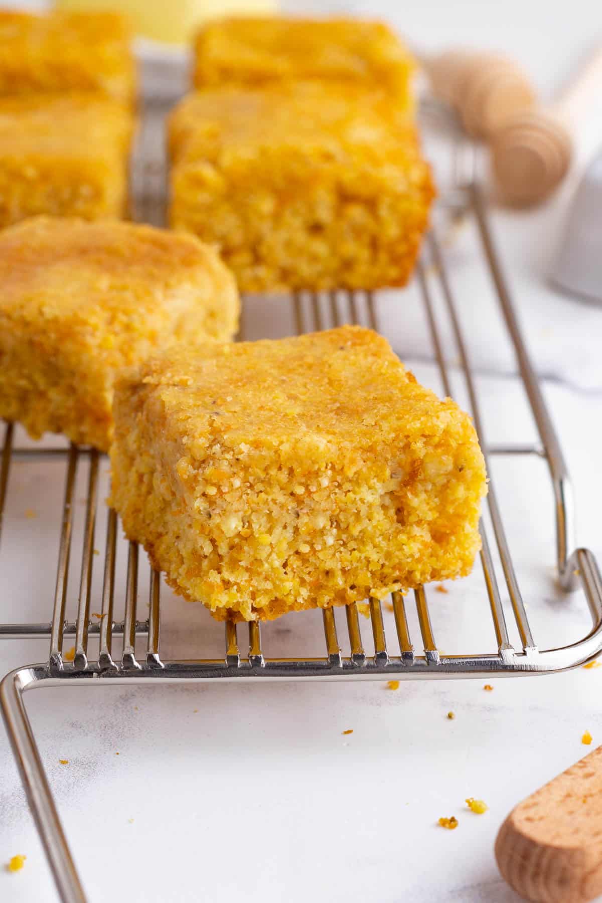 A slice of cornbread on a cooling rack.