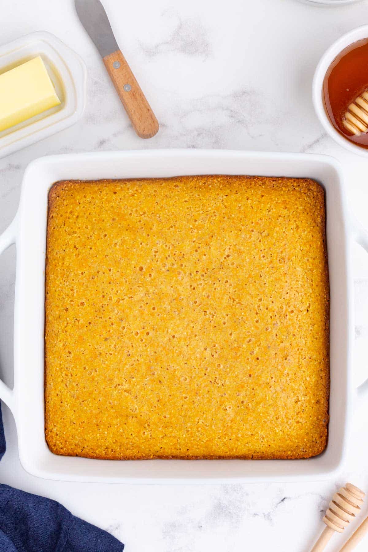 A white dish is full of gluten-free cornbread.