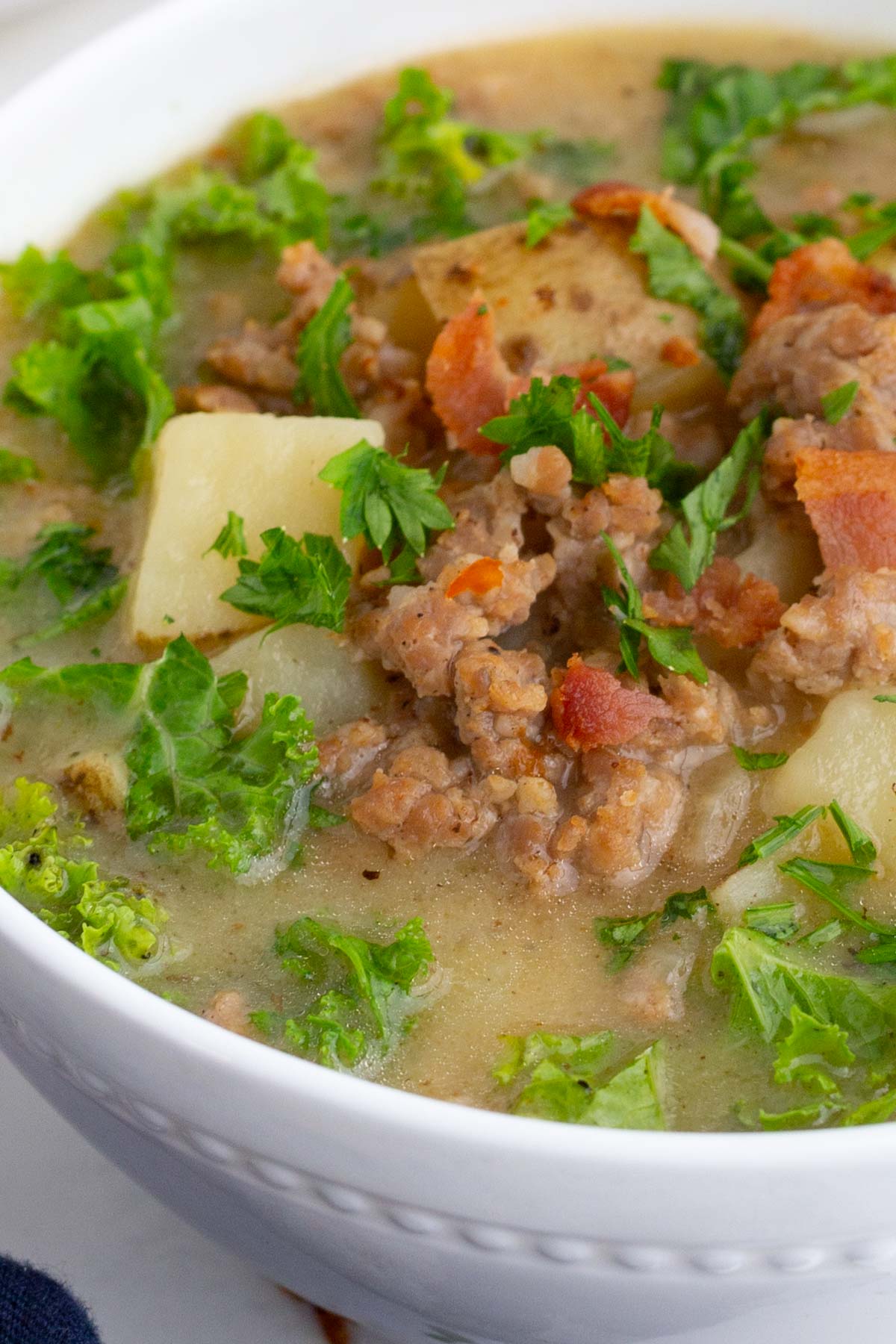 A closeup of a bowl with Zuppa Toscana.