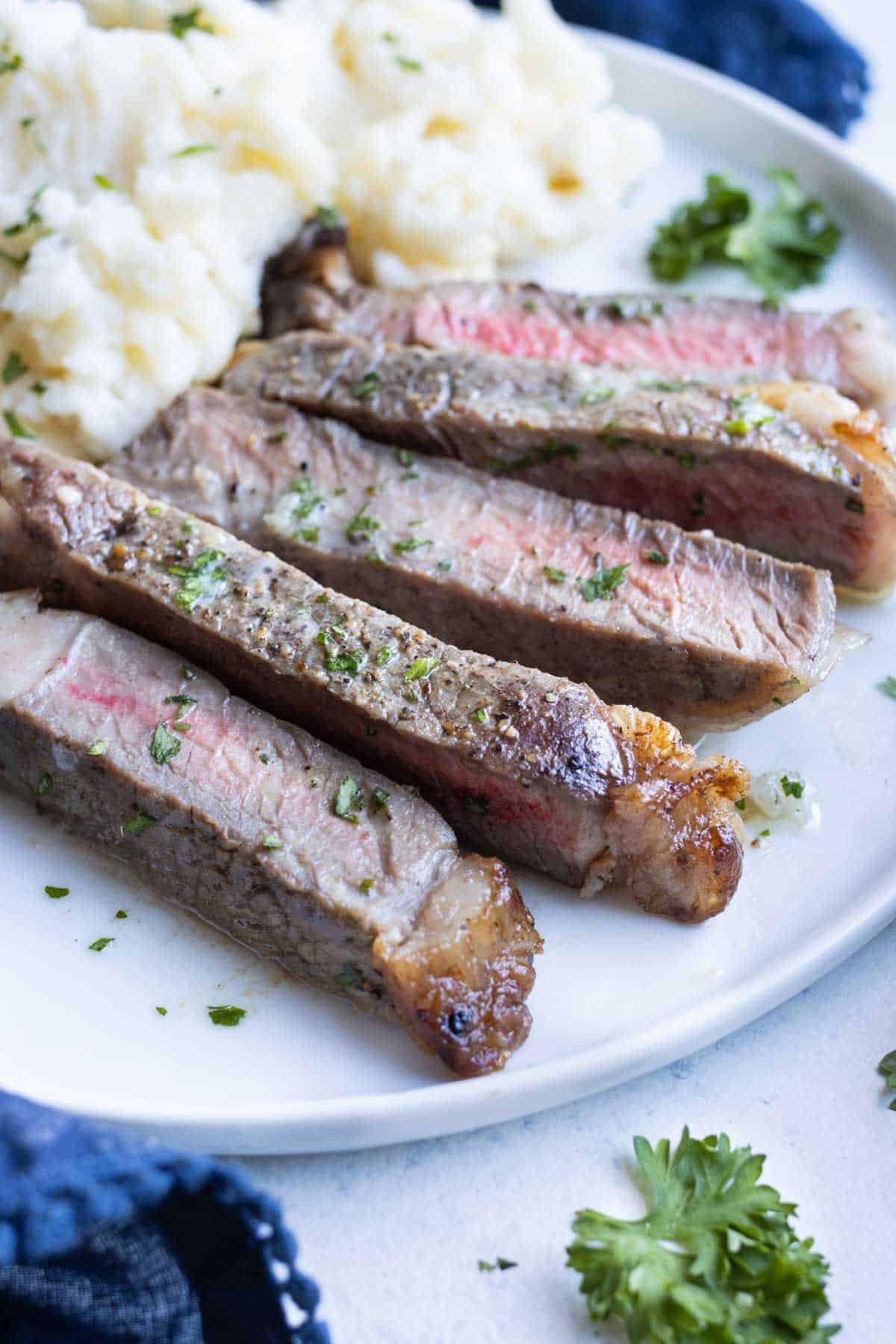 Sliced steak and mashed potatoes are a delicious and satisfying dinner.