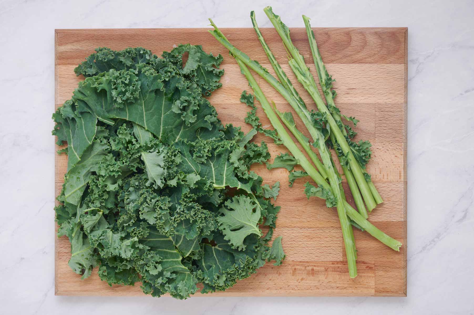 Kale leaves are removed from the stem.