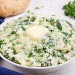 A pat of butter is placed in the middle of a bowl of colcannon.